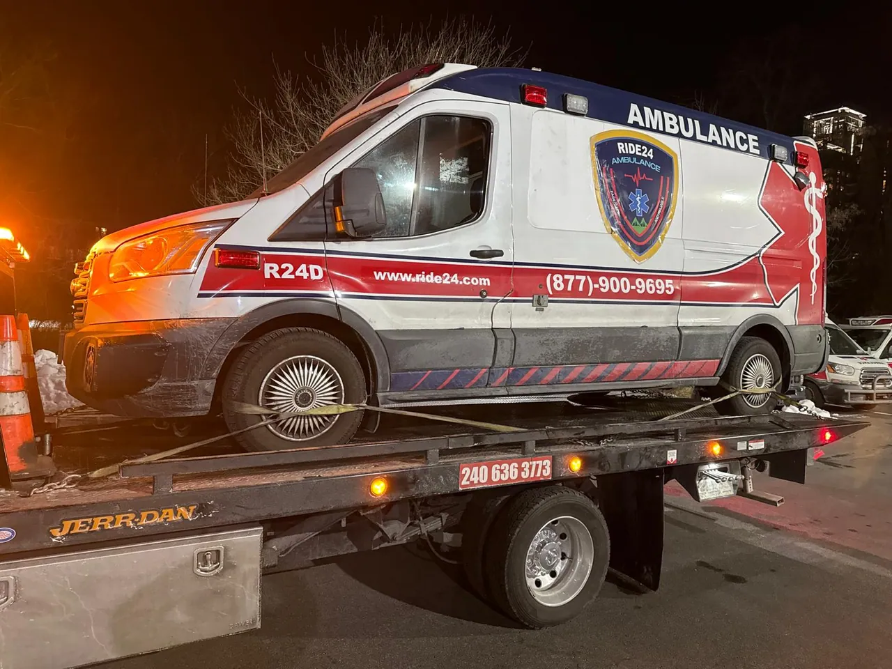An ambulance secured on a Barry Towing flatbed for transport